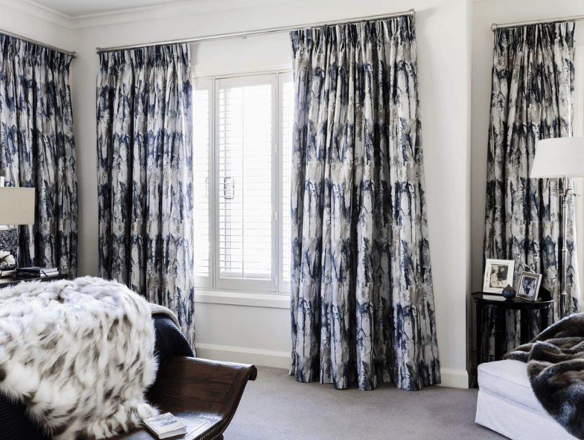 master bedroom thick drapery dark blue white furniture