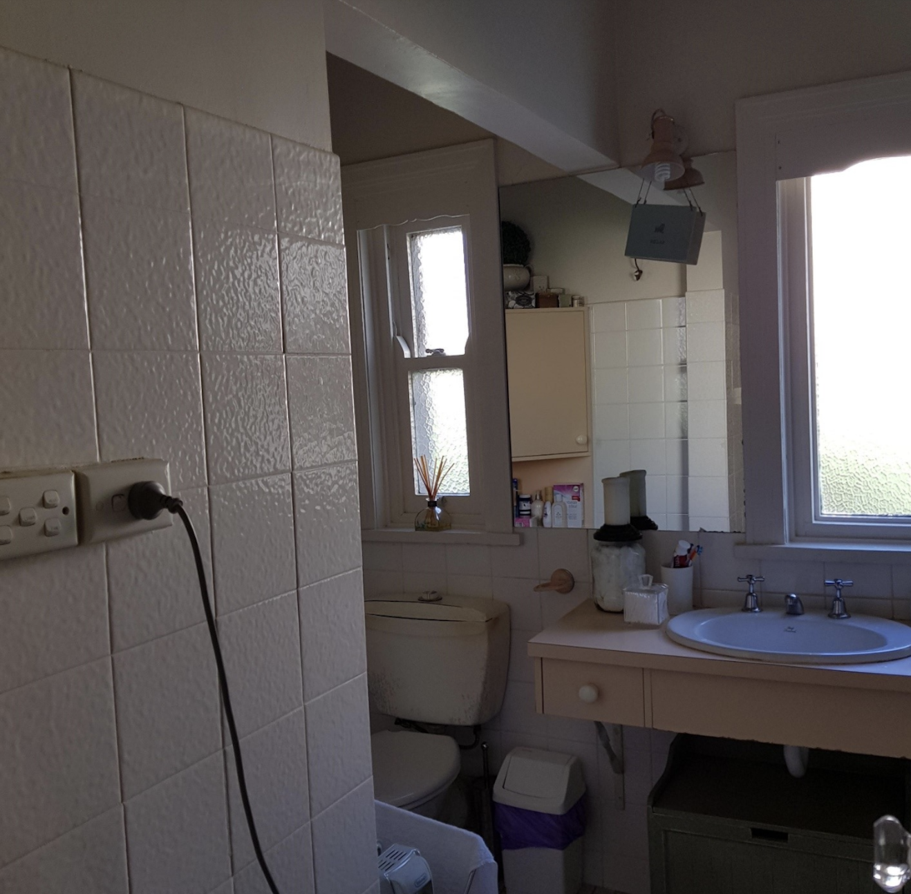 original 1930s bathroom before renovation strange power points off-center mirror